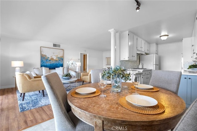 dining room with light wood-style floors and visible vents