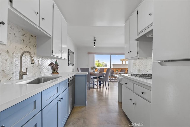 kitchen featuring white cabinetry, decorative backsplash, a sink, light countertops, and white appliances