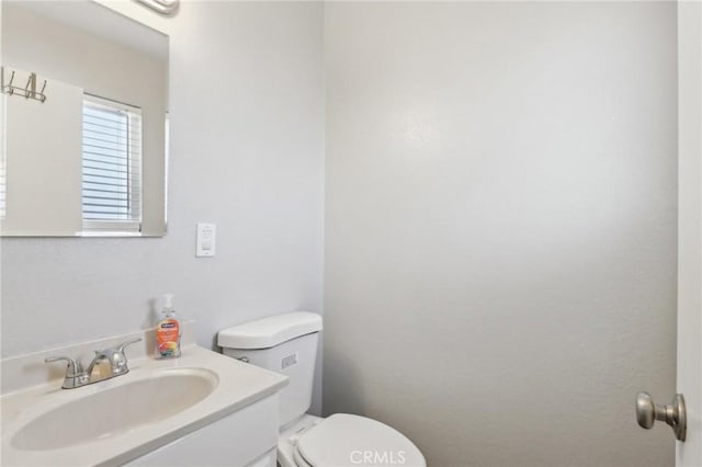 half bathroom featuring toilet and vanity
