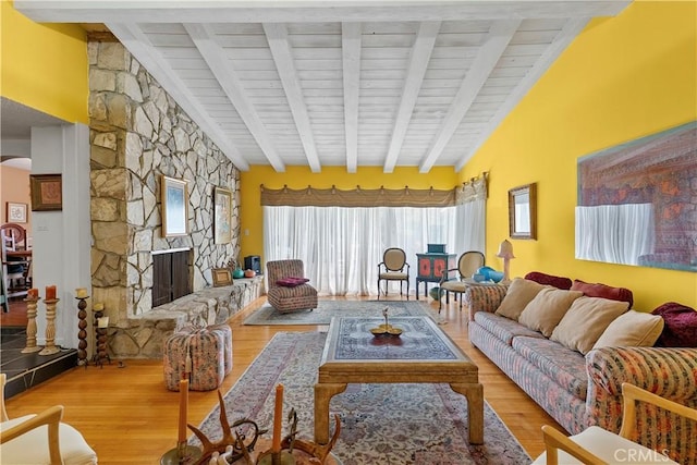 living room with wood finished floors, lofted ceiling with beams, and arched walkways