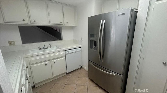 1224 Mohave Dr, Colton, CA 92324 - kitchen featuring dishwasher, stainless steel refrigerator with ice dispenser, tile countertops, and white cabinets