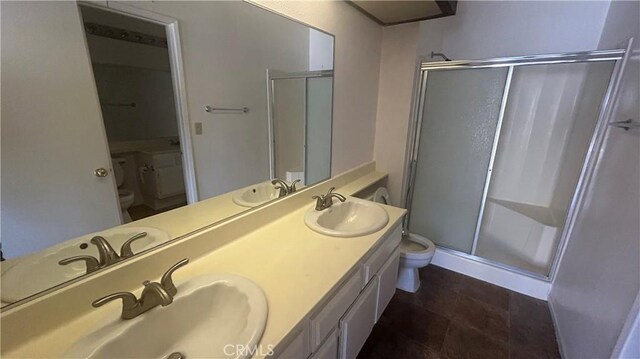 1224 Mohave Dr, Colton, CA 92324 - bathroom featuring toilet, a stall shower, and a sink