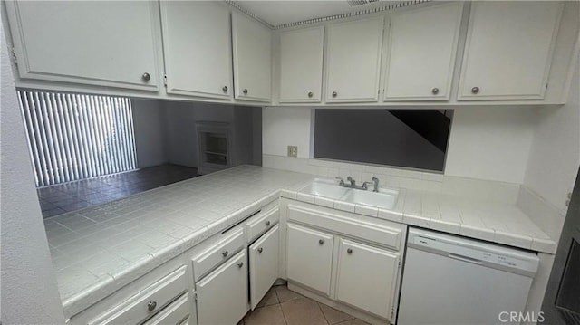 1224 Mohave Dr, Colton, CA 92324 - kitchen featuring a sink, light tile patterned floors, white cabinetry, tile countertops, and dishwasher