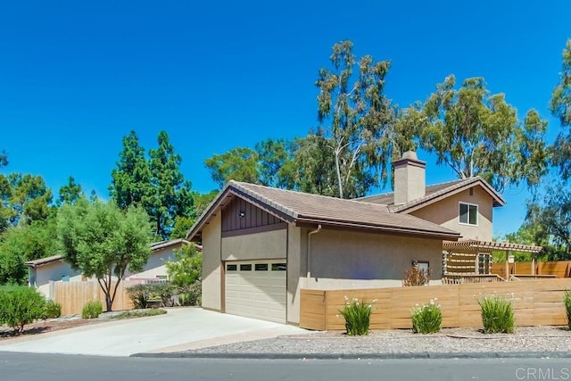 1023 Mimosa Ave, Vista, CA 92081 - view of front of home with a garage, concrete driveway, a chimney, and stucco siding