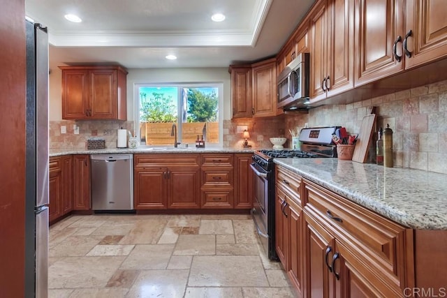 1023 Mimosa Ave, Vista, CA 92081 - kitchen with appliances with stainless steel finishes, brown cabinets, ornamental molding, backsplash, and light stone countertops