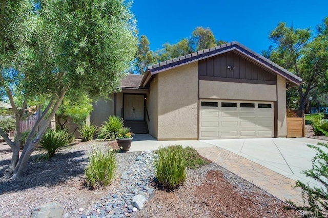 1023 Mimosa Ave, Vista, CA 92081 - view of front facade featuring concrete driveway, stucco siding, an attached garage, and a tiled roof