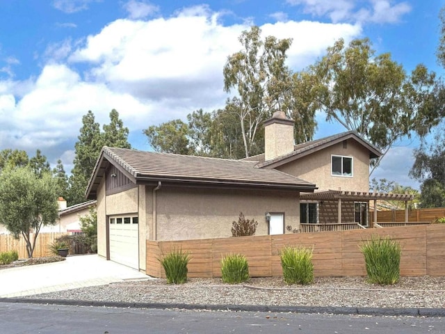 1023 Mimosa Ave, Vista, CA 92081 - view of front of property with stucco siding, a garage, a chimney, concrete driveway, and a pergola