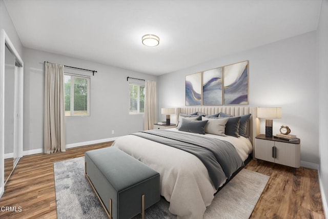 bedroom featuring baseboards and wood finished floors