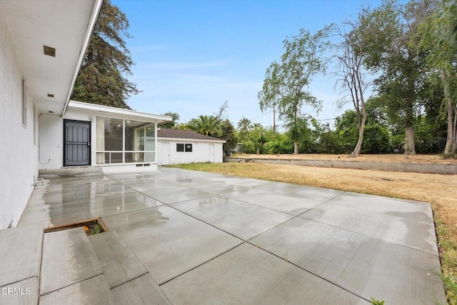 view of patio / terrace with a sunroom