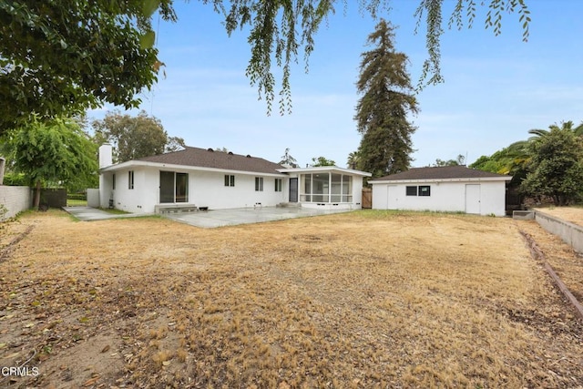 back of property with a patio, fence, a chimney, and a sunroom