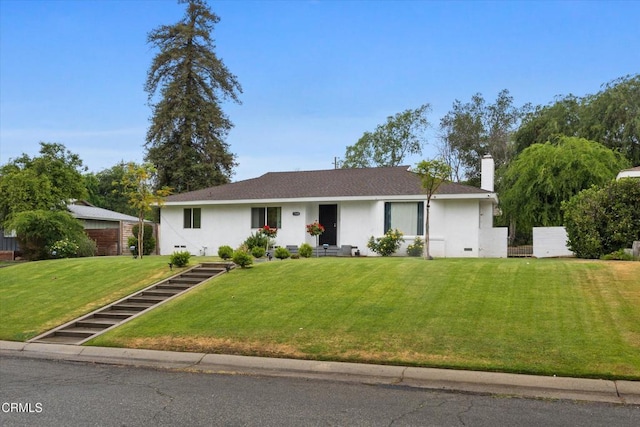 ranch-style home featuring stucco siding, a chimney, and a front lawn