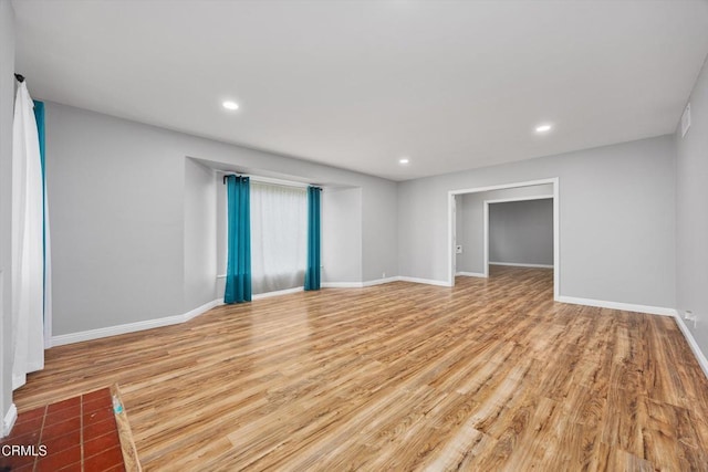 interior space with recessed lighting, visible vents, light wood-style flooring, and baseboards