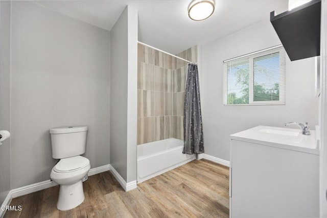 full bathroom with toilet, shower / tub combo with curtain, wood finished floors, and baseboards