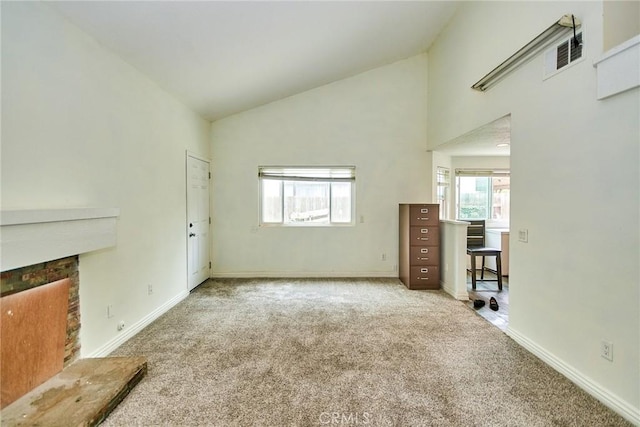 unfurnished living room with a fireplace, carpet floors, high vaulted ceiling, baseboards, and visible vents