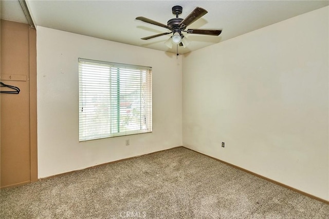 empty room with carpet and a ceiling fan