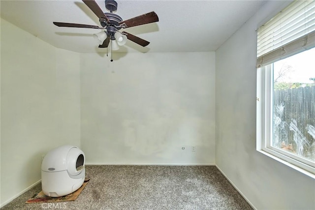 unfurnished room with carpet floors, ceiling fan, and baseboards