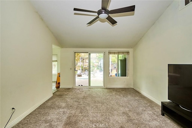 unfurnished living room with ceiling fan, visible vents, carpet floors, baseboards, and vaulted ceiling