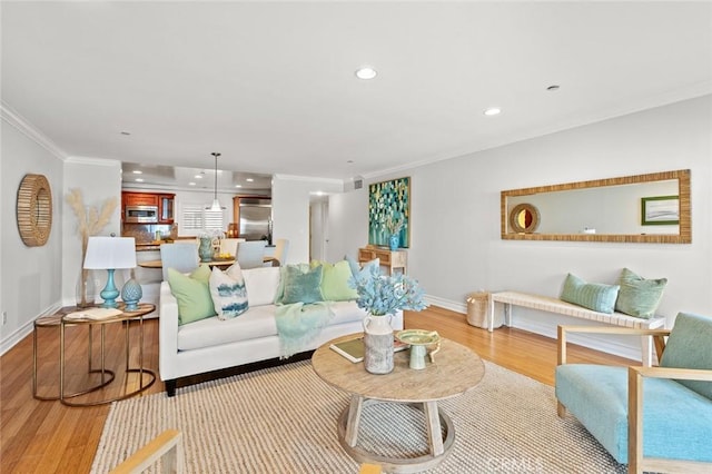 living room with baseboards, recessed lighting, wood finished floors, and ornamental molding