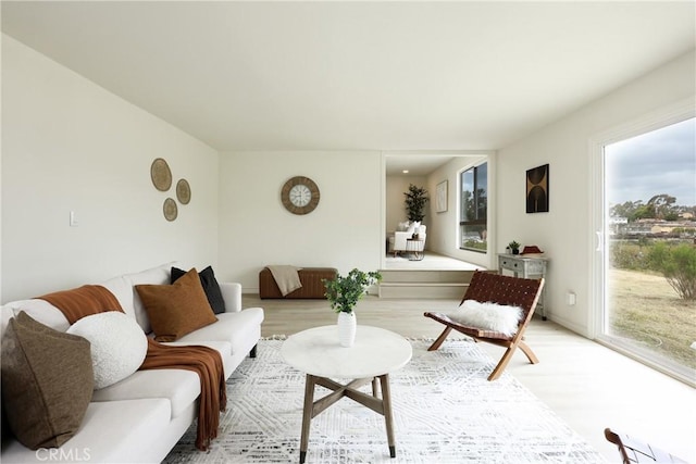 living room with light wood-style flooring and plenty of natural light