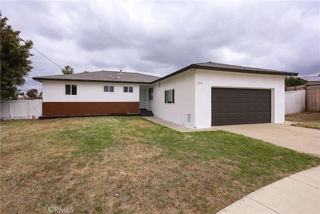 ranch-style home with an attached garage, entry steps, stucco siding, and fence