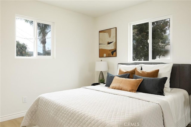 bedroom featuring light wood-style flooring and baseboards