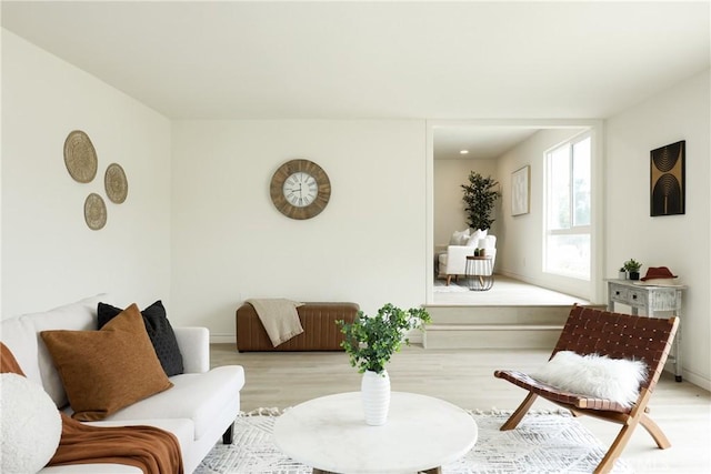living area featuring light wood-style floors and baseboards