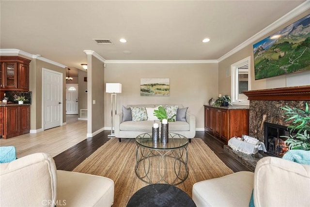 4820 Via Corzo, Yorba Linda, CA 92886 - living area with wood finished floors, ornamental molding, a high end fireplace, baseboards, and recessed lighting