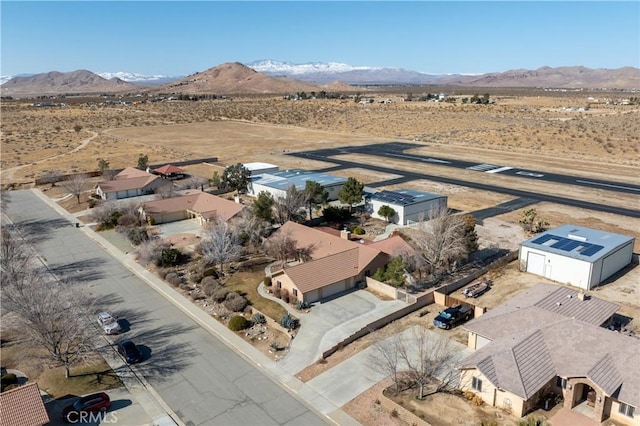 drone / aerial view with view of desert, a mountain view, and a rural view