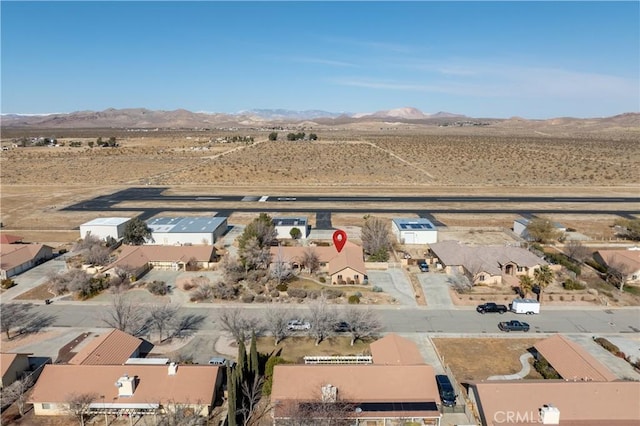 birds eye view of property with view of desert and a mountain view