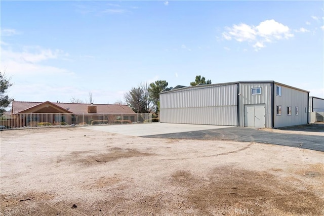 view of outbuilding featuring fence