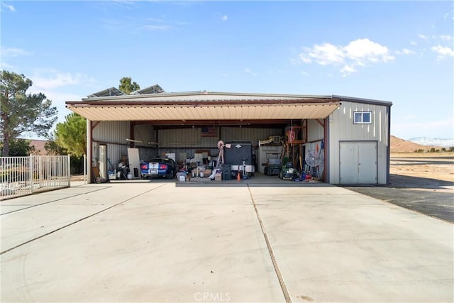 garage with fence and driveway