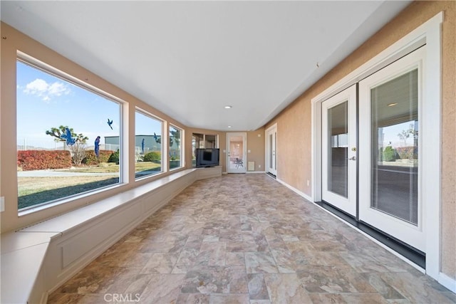 unfurnished sunroom with french doors