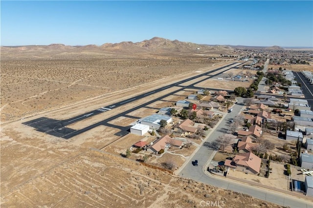 birds eye view of property featuring view of desert, a mountain view, and a residential view