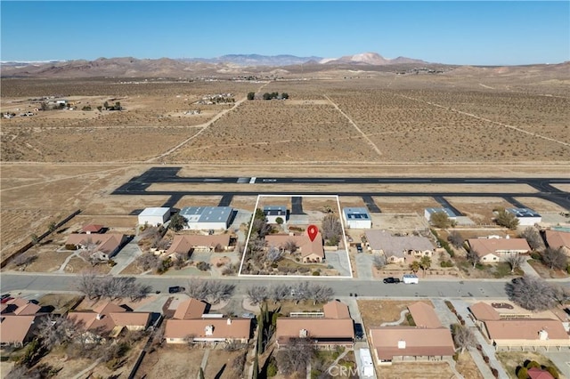 drone / aerial view featuring a mountain view and a desert view
