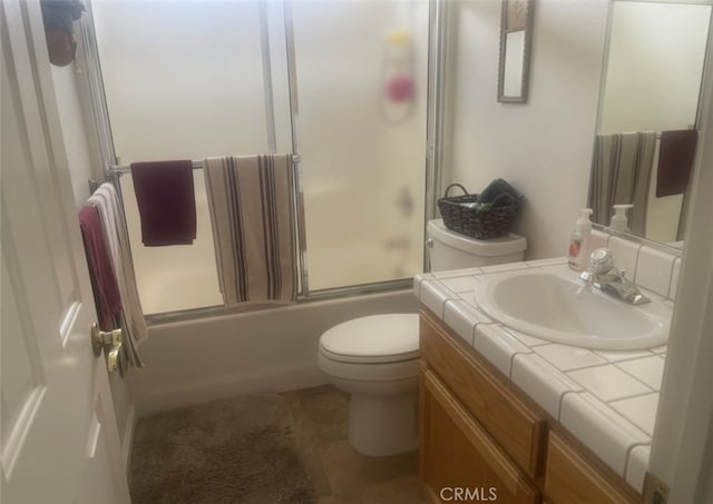 full bath with enclosed tub / shower combo, toilet, and vanity