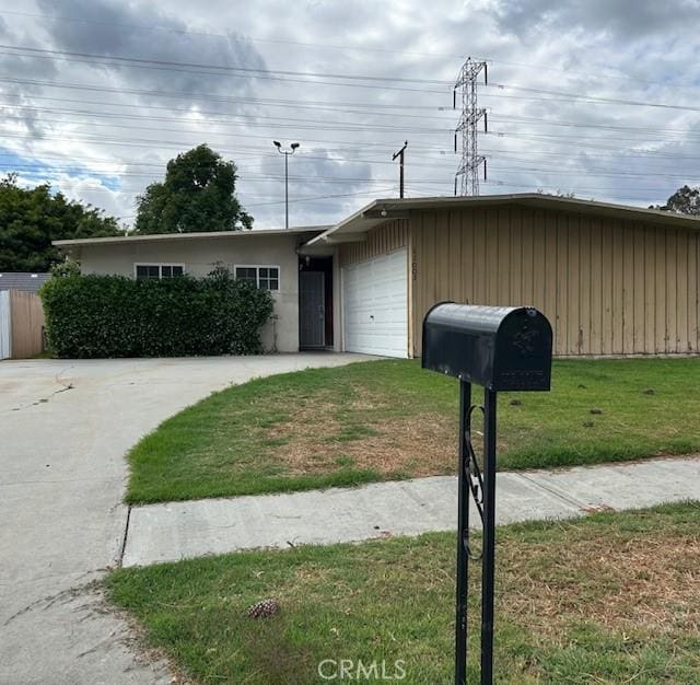 single story home featuring a front yard and a garage