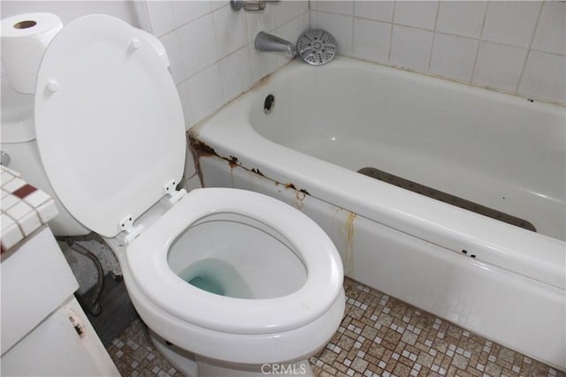 bathroom featuring a bathing tub and toilet