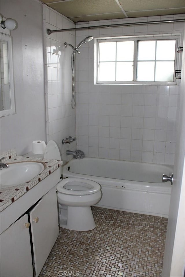 full bathroom featuring vanity, toilet, and  shower combination