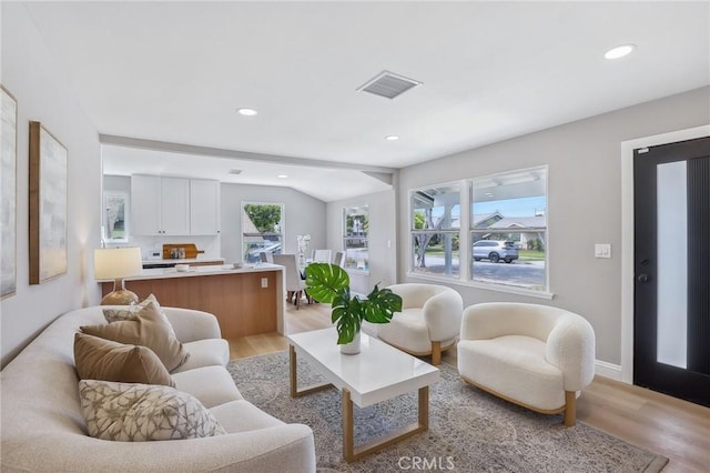 living room with light wood-type flooring, recessed lighting, baseboards, and visible vents