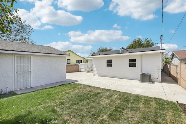 back of house with a fenced backyard, a patio, a lawn, and cooling unit