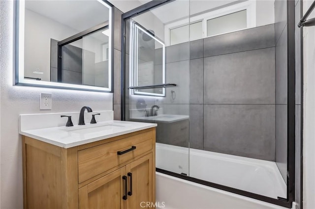 bathroom featuring vanity and combined bath / shower with glass door