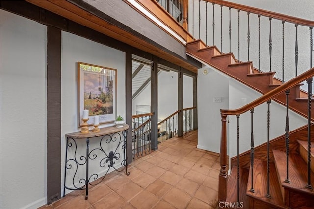 stairs with tile patterned floors and baseboards