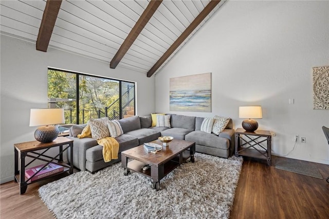 living area with beamed ceiling, high vaulted ceiling, and wood finished floors