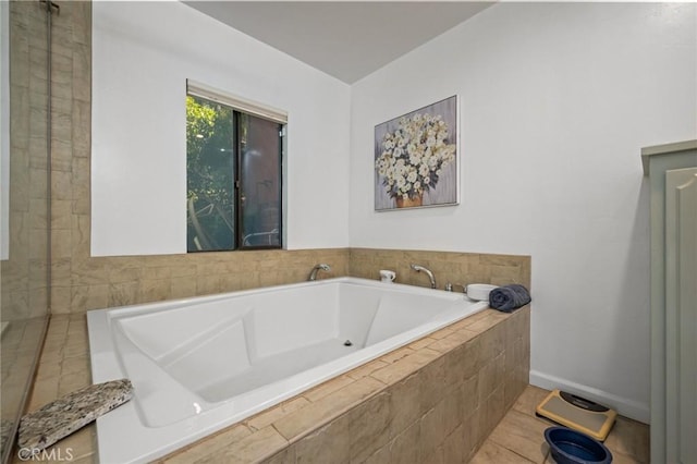 bathroom featuring baseboards and a garden tub