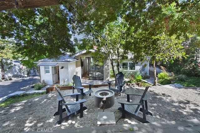 view of patio with a fire pit