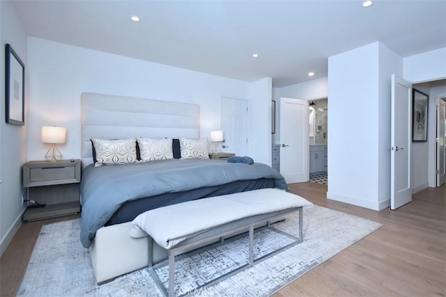 bedroom featuring wood finished floors, recessed lighting, and baseboards