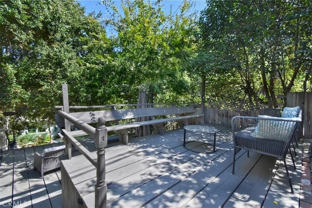 wooden terrace featuring fence