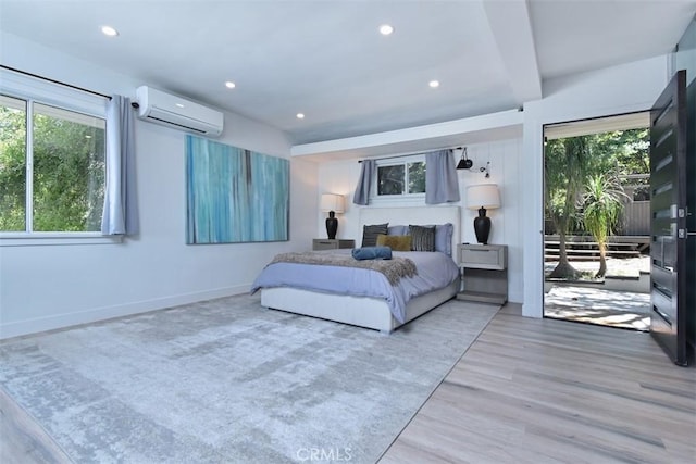 bedroom with recessed lighting, light wood finished floors, access to outside, and a wall mounted AC