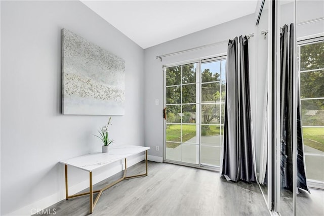 5211 Mcclintock Ave, Temple City, CA 91780 - doorway to outside featuring a healthy amount of sunlight, baseboards, light wood-style flooring, and lofted ceiling