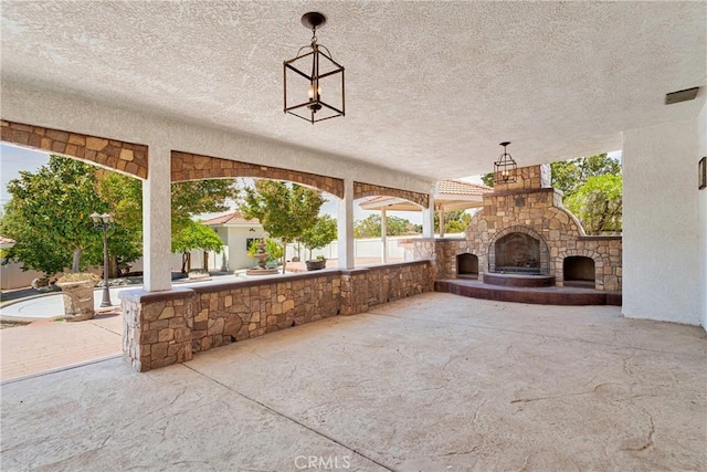 view of patio featuring an outdoor stone fireplace